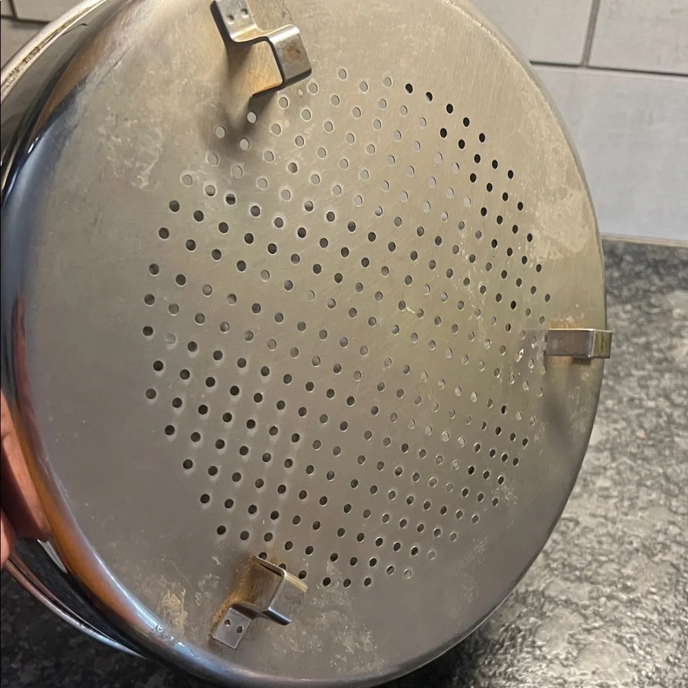 Stainless Steel Steamer Basket 9.5”. Has feet to sit above water to steam.